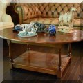 F16. Tiered wooden coffee table. 19”h x 48”w x 33”d 